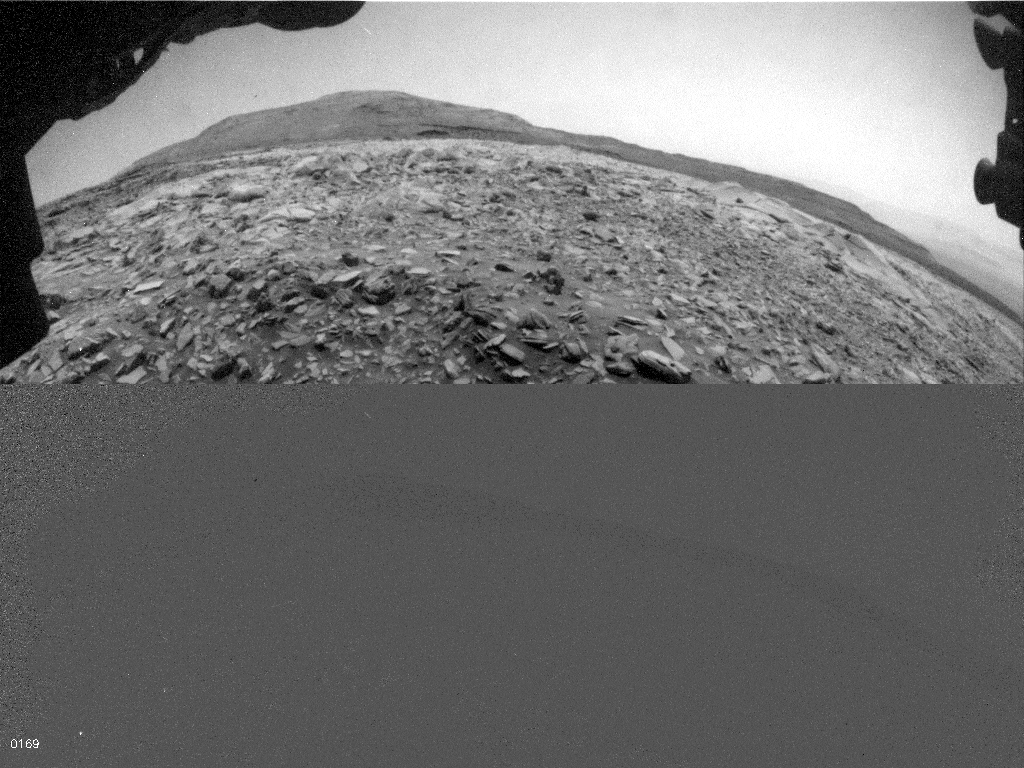 NASA’s Curiosity Mars rover used one of its Hazcams to catch this apparent dusty wind gust blowing overhead on March 18, 2022, the 3,418th Martian day, or sol, of the mission.