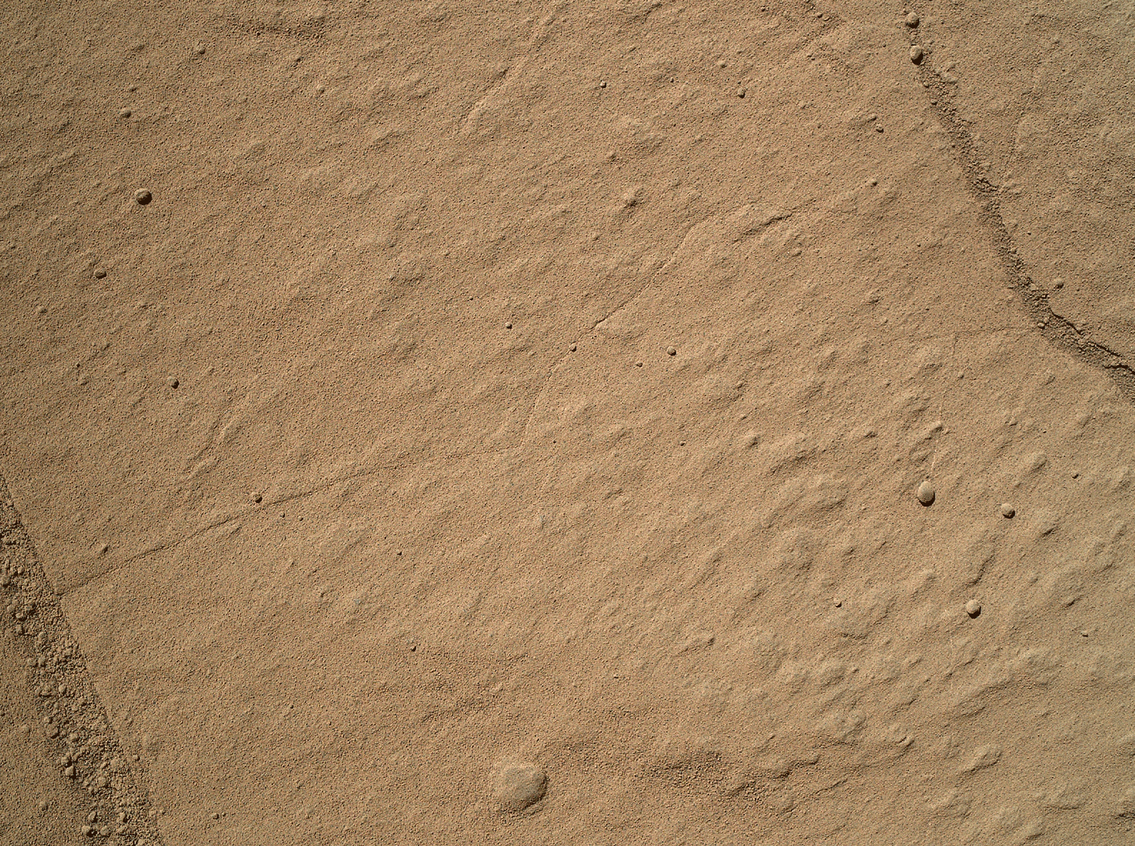 This two-step animation shows before and after views of a patch of sandstone scrubbed with the Dust Removal Tool, a wire-bristle brush, on NASA's Curiosity Mars rover.