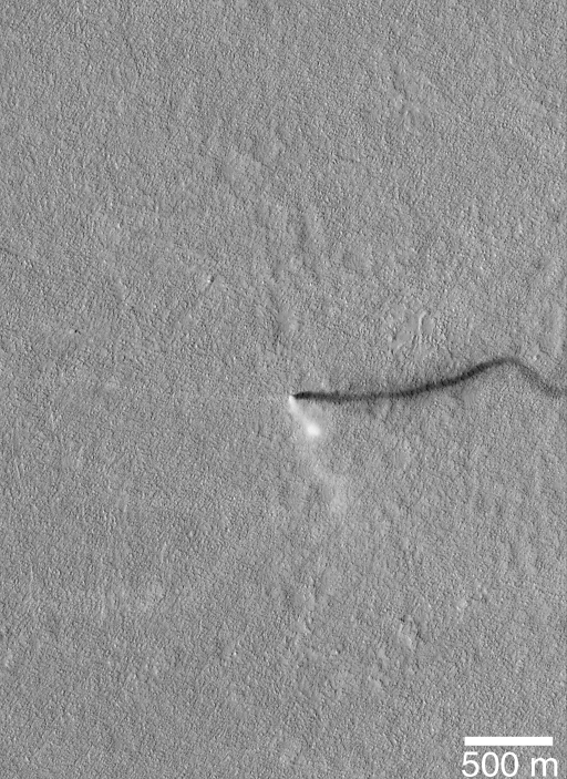 The Mars Global Surveyor (MGS) spacecraft Mars Orbiting Camera (MOC) took this image of a dust devil skidding across the landscape in the Amazonis Planitia region of Mars.