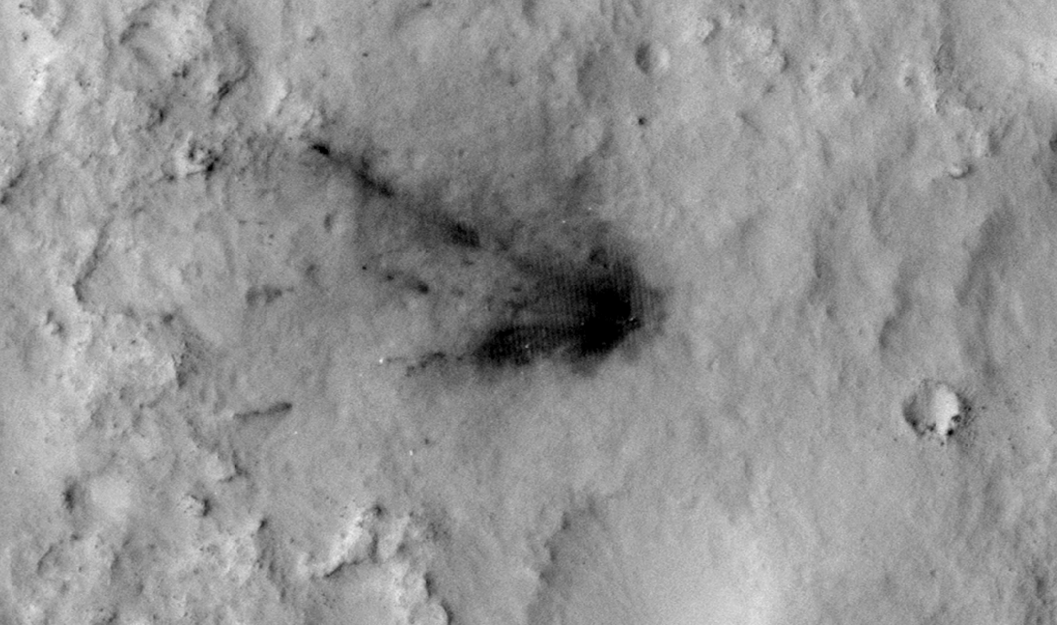 This sequence of images shows a blast zone where the sky crane from NASA's Curiosity rover mission hit the ground after setting the rover down in August 2012, and how that dark scar's appearance changed over the subsequent 30 months. The images are from HiRISE on NASA's Mars Reconnaissance Orbiter.