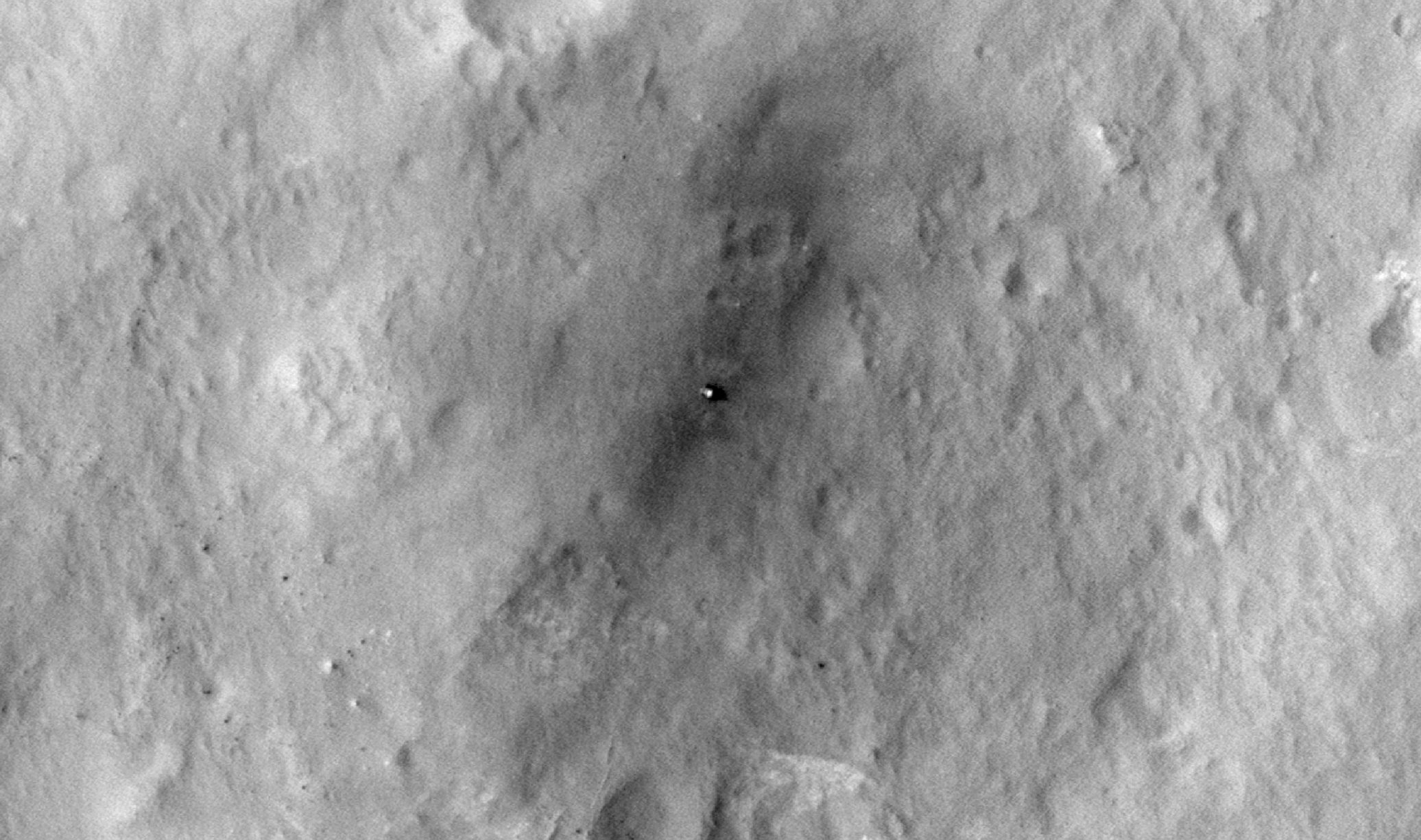 This sequence of images shows a blast zone where the sky crane from NASA's Curiosity rover mission hit the ground after setting the rover down in August 2012, and how that dark scar's appearance changed over the subsequent 30 months. The images are from HiRISE on NASA's Mars Reconnaissance Orbiter.