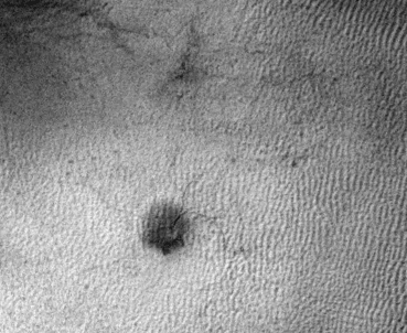 This sequence of three HiRISE images from NASA's Mars Reconnaissance Orbiter shows the growth of a branching network of troughs carved by thawing carbon dioxide over the span of three Martian years. This process may also form larger radially patterned channel features known as Martian "spiders."