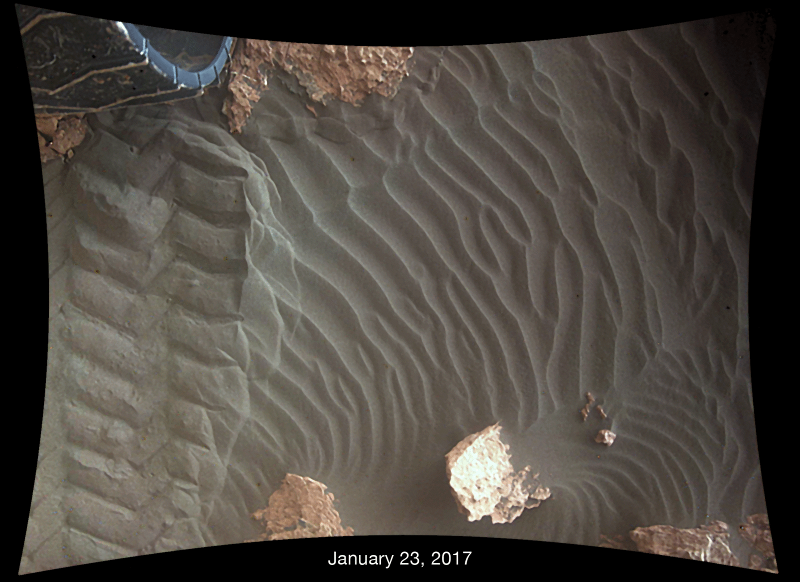 This pair of images shows effects of one Martian day of wind blowing sand underneath NASA's Curiosity Mars rover on a non-driving day for the rover. Each image was taken just after sundown by the rover's Mars Descent Imager (MARDI). The area of ground shown spans about 3 feet left-to-right.