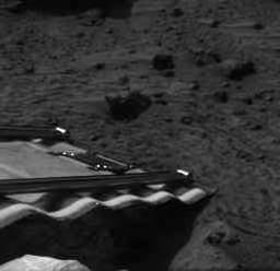 At approximately 10:40 pm Pacific Daylight Time today, 5 July 1997, the Sojourner Rover drove off the rear lander ramp onto the Martian surface. The accompanying animation was assembled from 9 separate images taken by the IMP. The descent took approximately 2 minutes to complete. The rover now rests on the Martian soil, 10 cm from the end of the ramp.