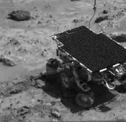 This image is of the Mars Pathfinder rover deploying its Alpha Proton X-Ray Spectrometer (APXS).