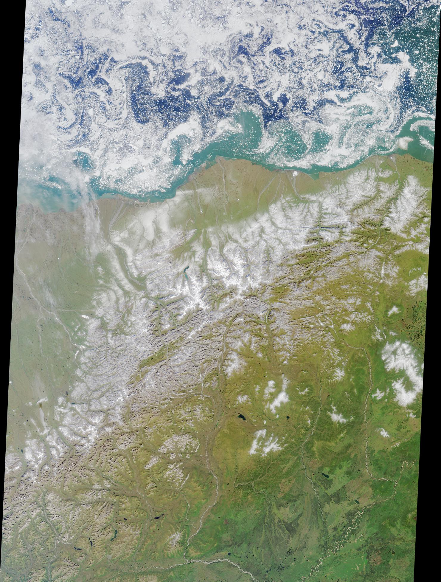NASA Terra MISR satellite image of the Arctic National Wildlife Refuge coastal plain and Beaufort Sea showing swirling ice floes the Canning River western boundary and the US-Canadian border eastern boundary