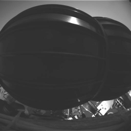 This image taken at Meridiani Planum, shows NASA's Mars Exploration Rover Opportunity's wheels in their stowed configuration. As January 28, 2004, the rover had deployed its wheels and completed the first half of the stand-up process.