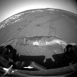 This image shows NASA's Mars Exploration Rover Opportunity's arm exploring the trench the rover dug with one of its wheels. The arm holds a suite of scientific instruments designed to examine rocks and soil for signs of past water on Mars.