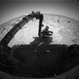 This image shows NASA's Mars Exploration Rover Opportunity brushing bright materials off a circular patch of the rock dubbed 'Mazatzal.' The freshly exposed rock was investigated by instruments on the rover's arm March 25, 2004.