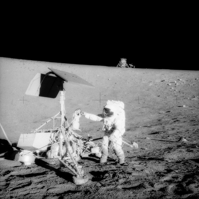Apollo 12 astronaut Charles Conrad examines the Surveyor 3 spacecraft on the Moon