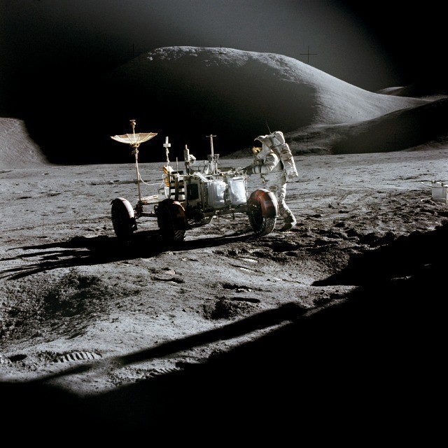 Apollo 15 astronaut James Irwin working beside the lunar rover at Hadley-Apennine
