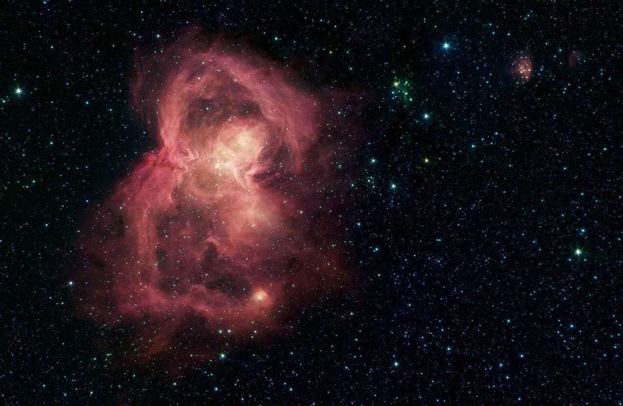 Officially known as W40, this red butterfly in space is a nebula, or a giant cloud of gas and dust. The "wings" of the butterfly are giant bubbles of gas being blown from the inside out by massive stars. Credit: NASA/JPL-Caltech