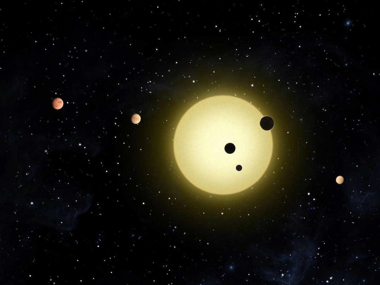 Artist's rendering of six planets orbiting a Sun-like star, Kepler-11. A newly discovered system, also likely with six planets, includes a "super-Earth" and four "mini-Neptunes." Image credit: NASA/Tim Pyle.