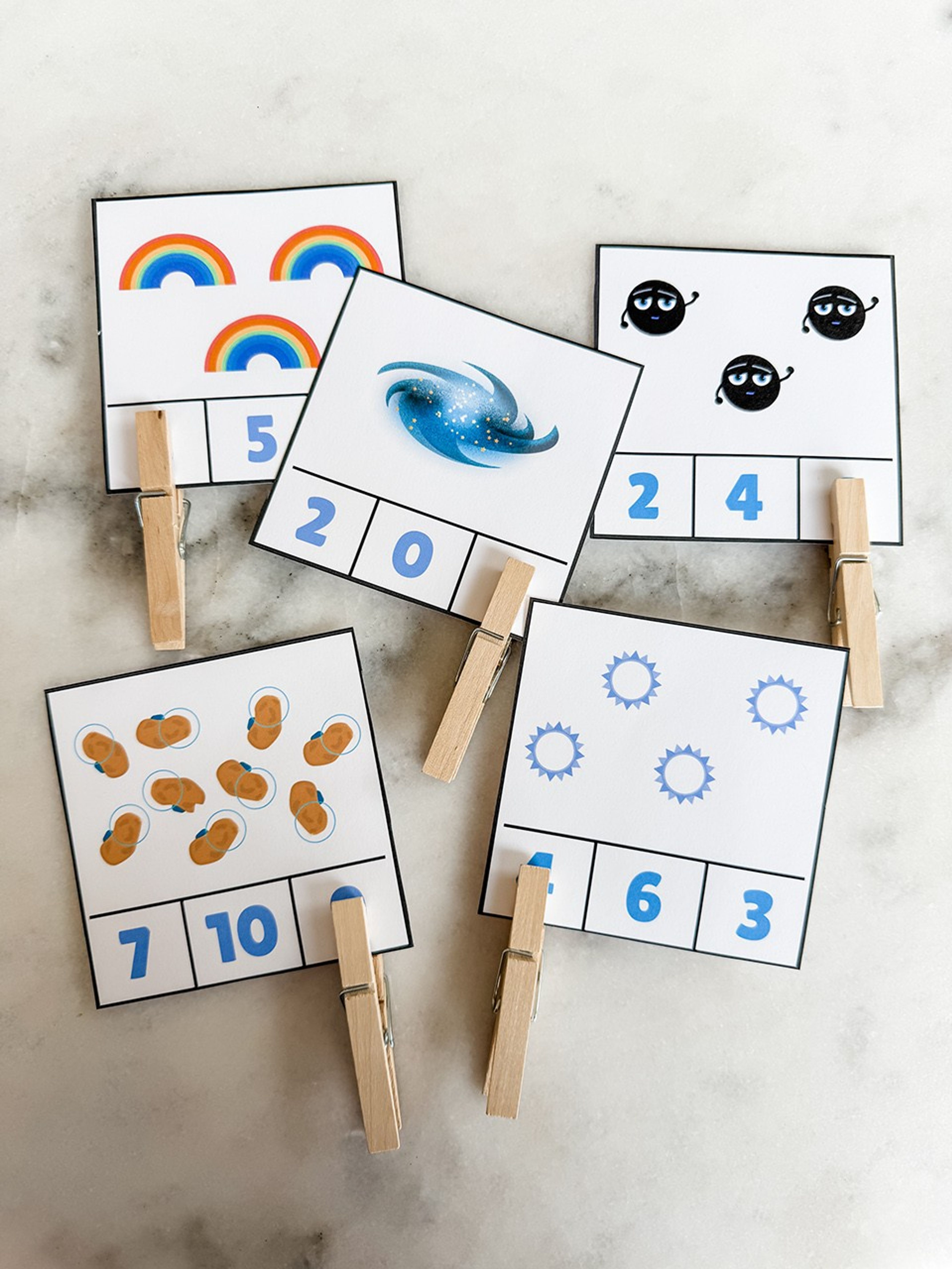 Photo showing clip counting printouts in use with clothespins marking the correct answers.