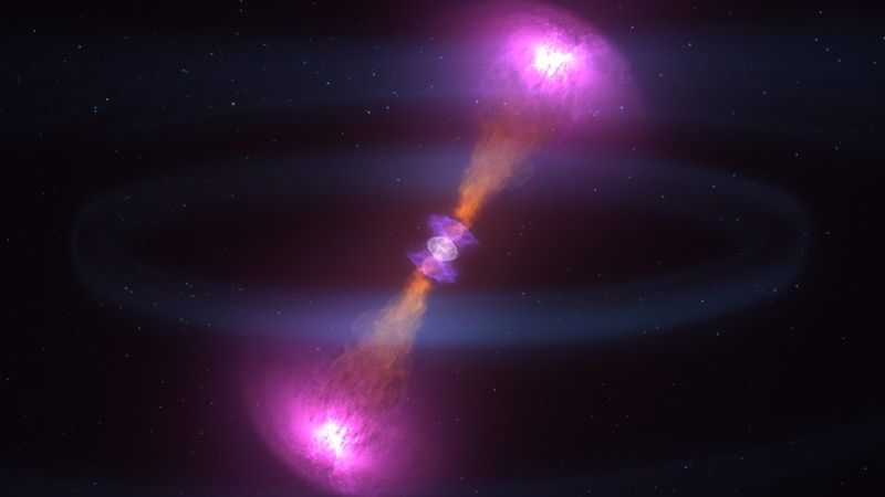 This animation of a gamma-ray burst shows two jets of material that look like two orange cones connected by their points and facing in opposite directions, one opening up and to the right of the center, the other opening down and to the left. The ends of the cones have bright magenta light, which represent an expanding shock wave. At the center is a wrapped-candy-shaped blue structure lined up with the jets which represents the kilonova, the neutron-rich debris of the explosion.