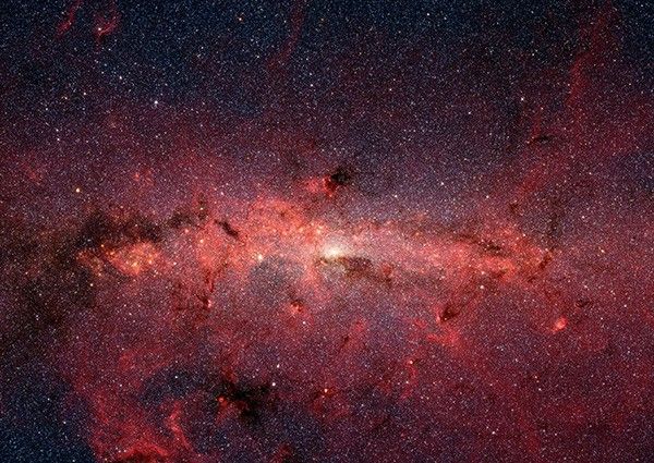 The center of our Milky Way galaxy is hidden from the prying eyes of optical telescopes by clouds of obscuring dust and gas. But in this stunning vista, NASA's Spitzer Space Telescope's infrared cameras penetrate much of the dust, revealing the stars of the crowded galactic center region.