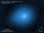 An image from NASA’s Hubble Space Telescope showing the interstellar comet 3I/ATLAS. The comet is a small white dot in the center of the image, with a light blue halo of light that takes up most of the image. Other stars are shown streaking across the image as diagonal blue-white lines.