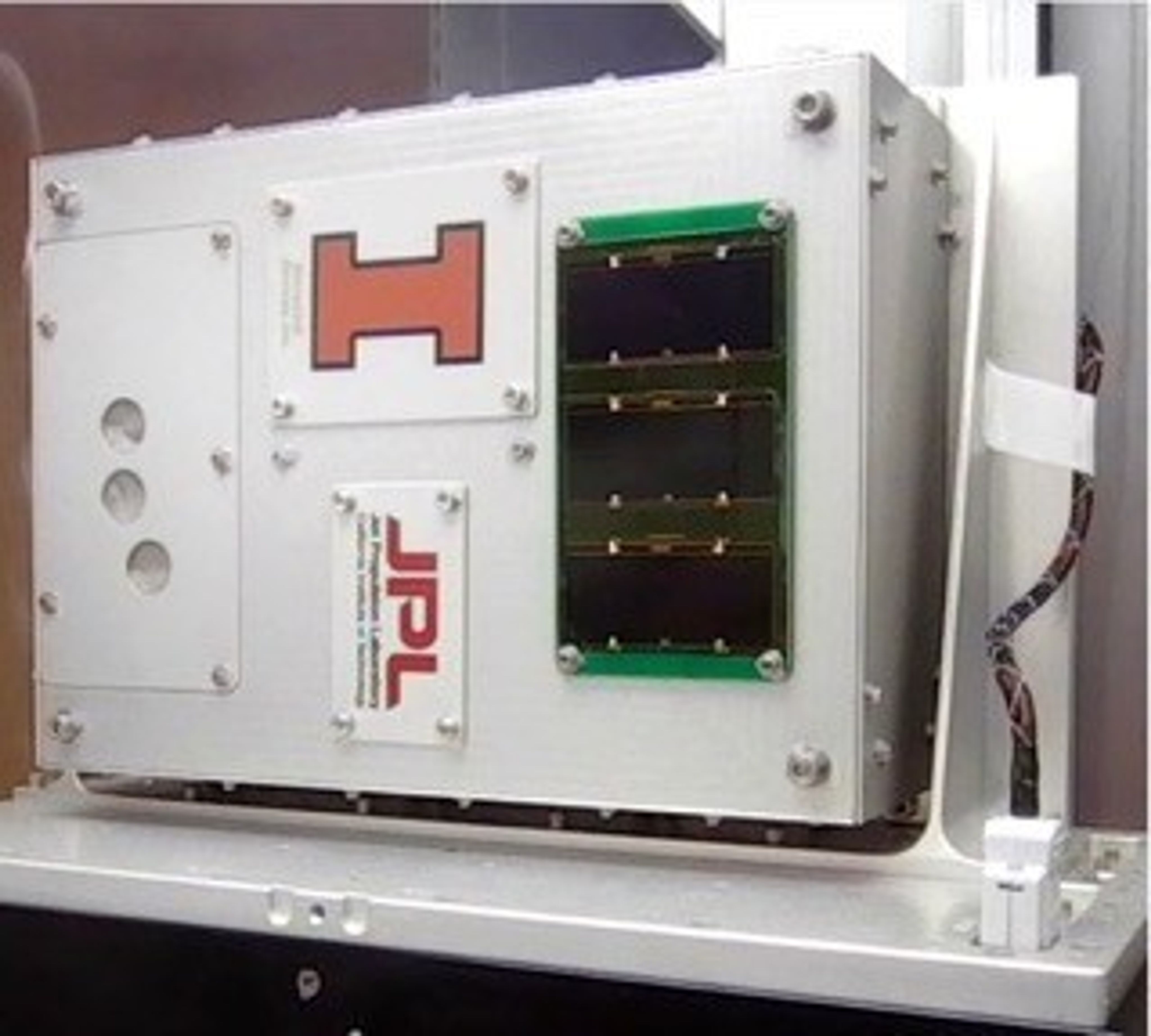 The SEAQUE platform is a rectangle 3-D box with four smaller rectangle plates screwed on to the box that contains software to perform experiments on the space station.