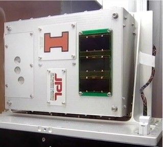 The SEAQUE platform is a rectangle 3-D box with four smaller rectangle plates screwed on to the box that contains software to perform experiments on the space station.