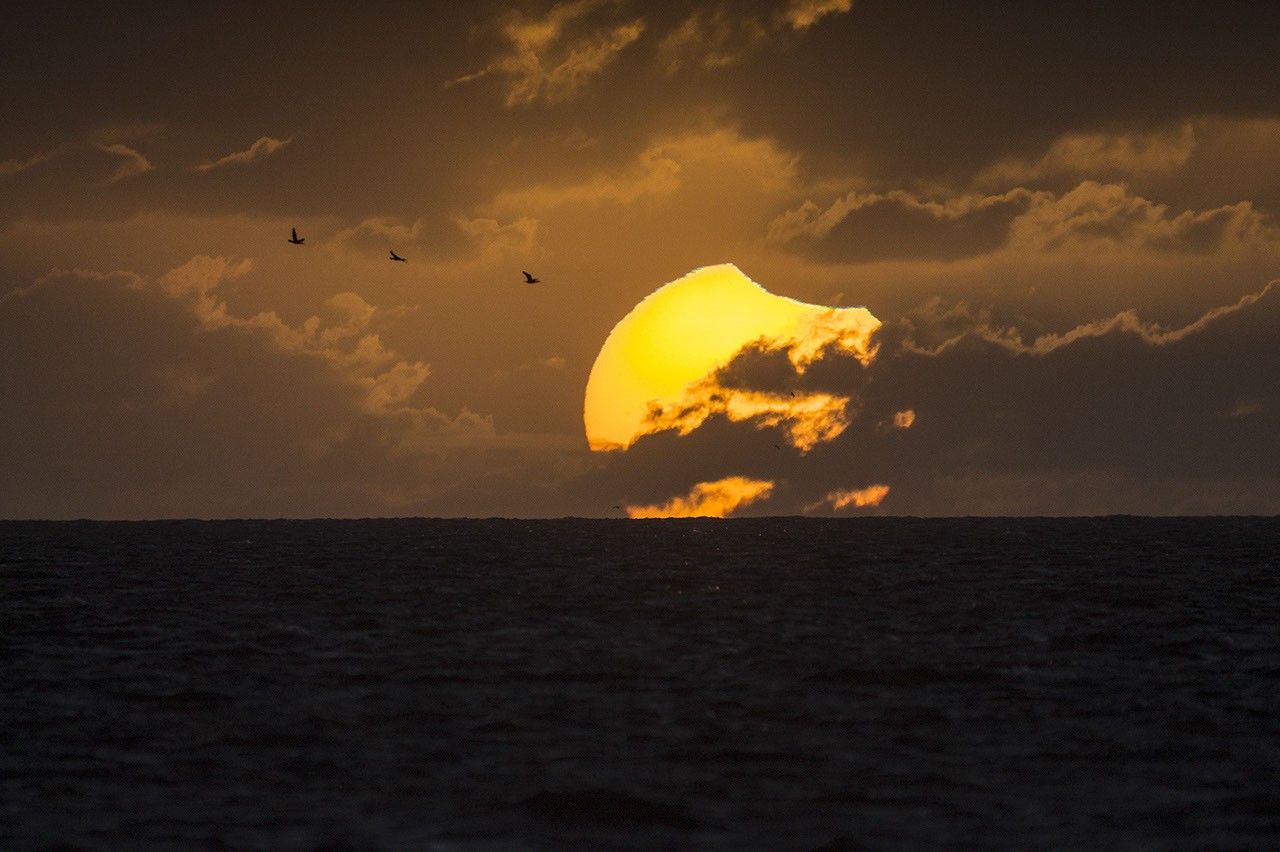 A Partially Eclipsed Setting Sun