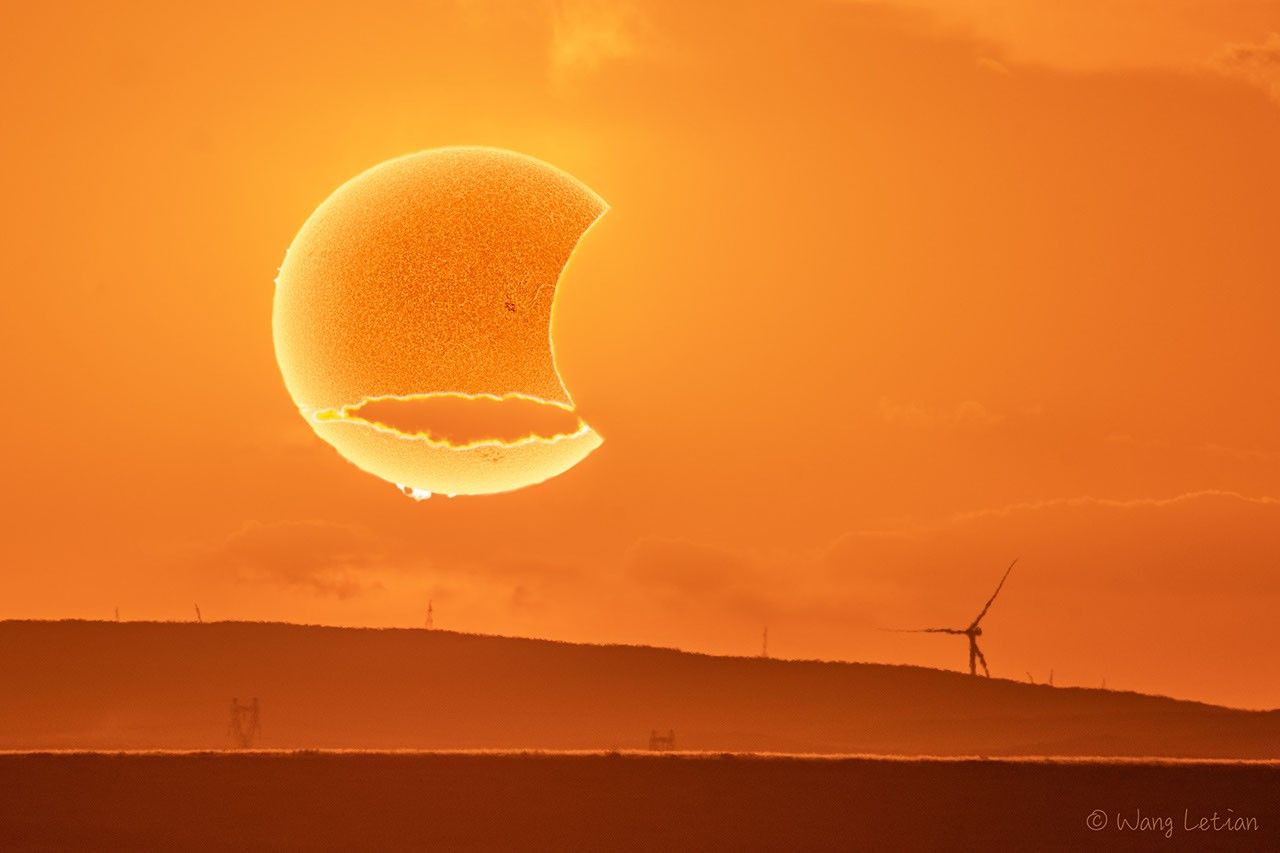 The picture shows an artistic photograph of a partial solar eclipse. Please see the explanation for more detailed information.