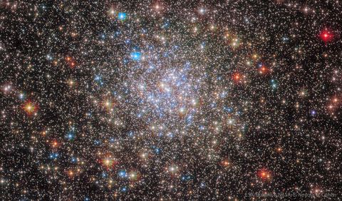 A ball of stars containing thousands of stars is shown with mostly light colored stars but with some stars having vibrant colors. Please see the explanation for more detailed information.