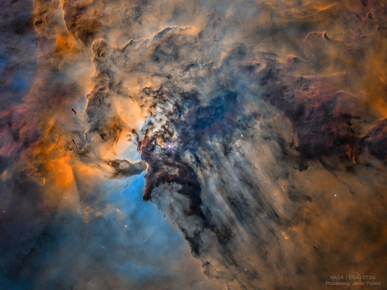 The center of the Lagoon Nebula is pictured in false colors. Toward the center left, dark dust swirls around glowing gas and bright stars. Please see the explanation for more detailed information.