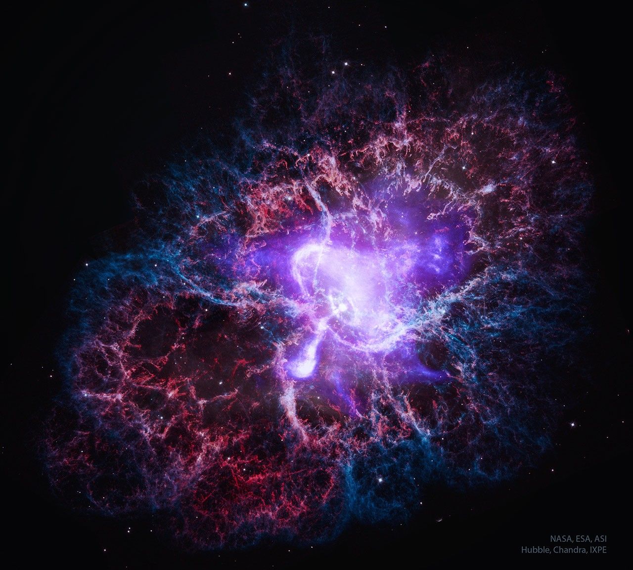A multi-colored nebula is shown that is the expanding remnant of an exploded star. The central white and purple colors show X-ray light, while the outer red and blue colors show visible light. Please see the explanation for more detailed in