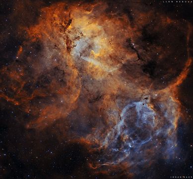 A starfield is shown with a large colorful emission nebula in the center. The outline of this emission nebula has a resemblance to a lion. Please see the explanation for more detailed information.
