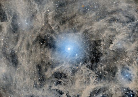 A bright star is pictured in the center of field filled with glowing gas and dust and other, more faint, stars. Please see the explanation for more detailed information.