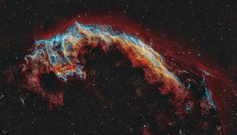 The featured image shows a starfield with a multi- colored nebula in the center. The nebula is quite filamentary but appears to some like a bat. Please see the explanation for more detailed information.