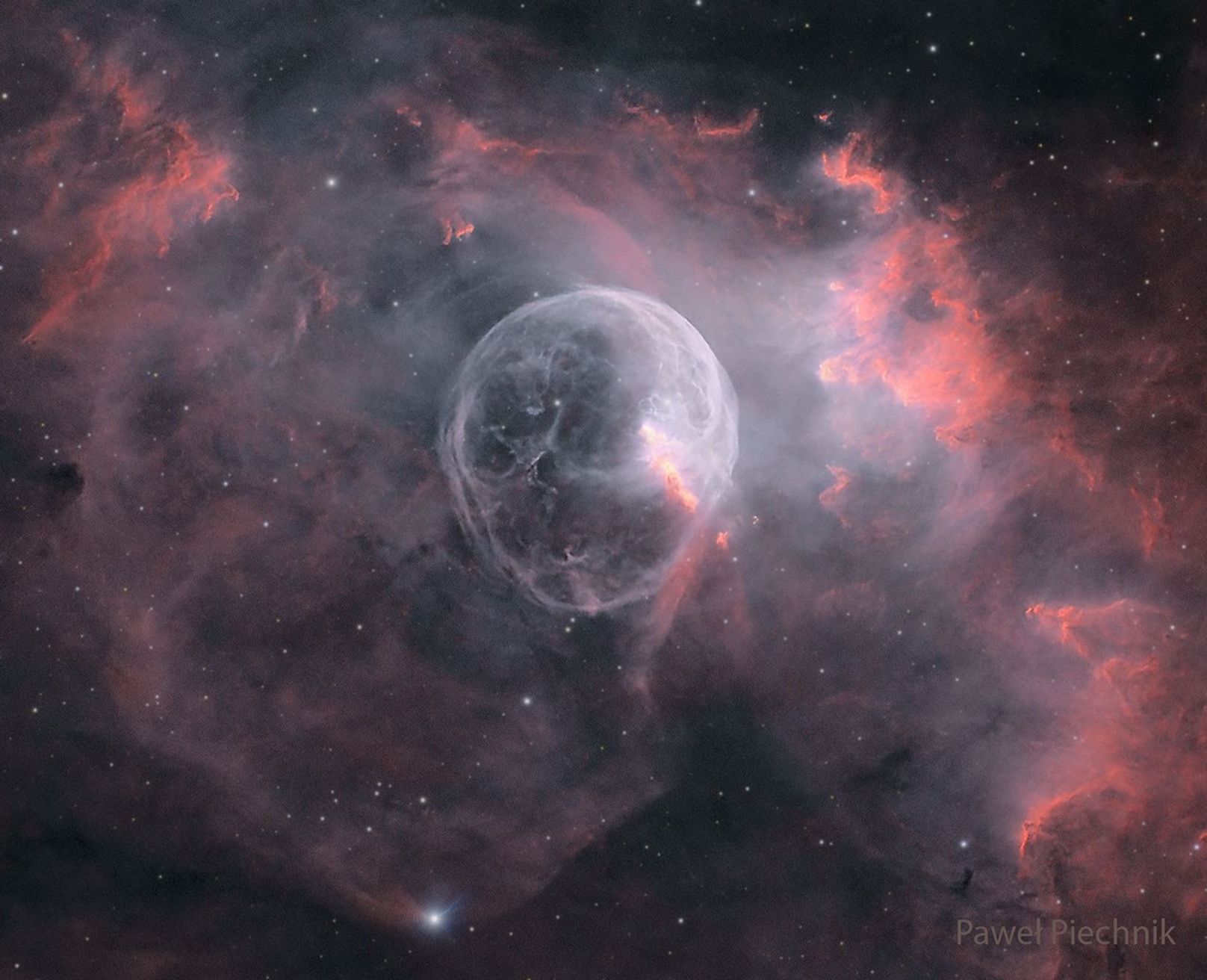 A starfield is shown with a big light bubble in the center. To some, the bubble may resemble a skull. Please see the explanation for more detailed information.