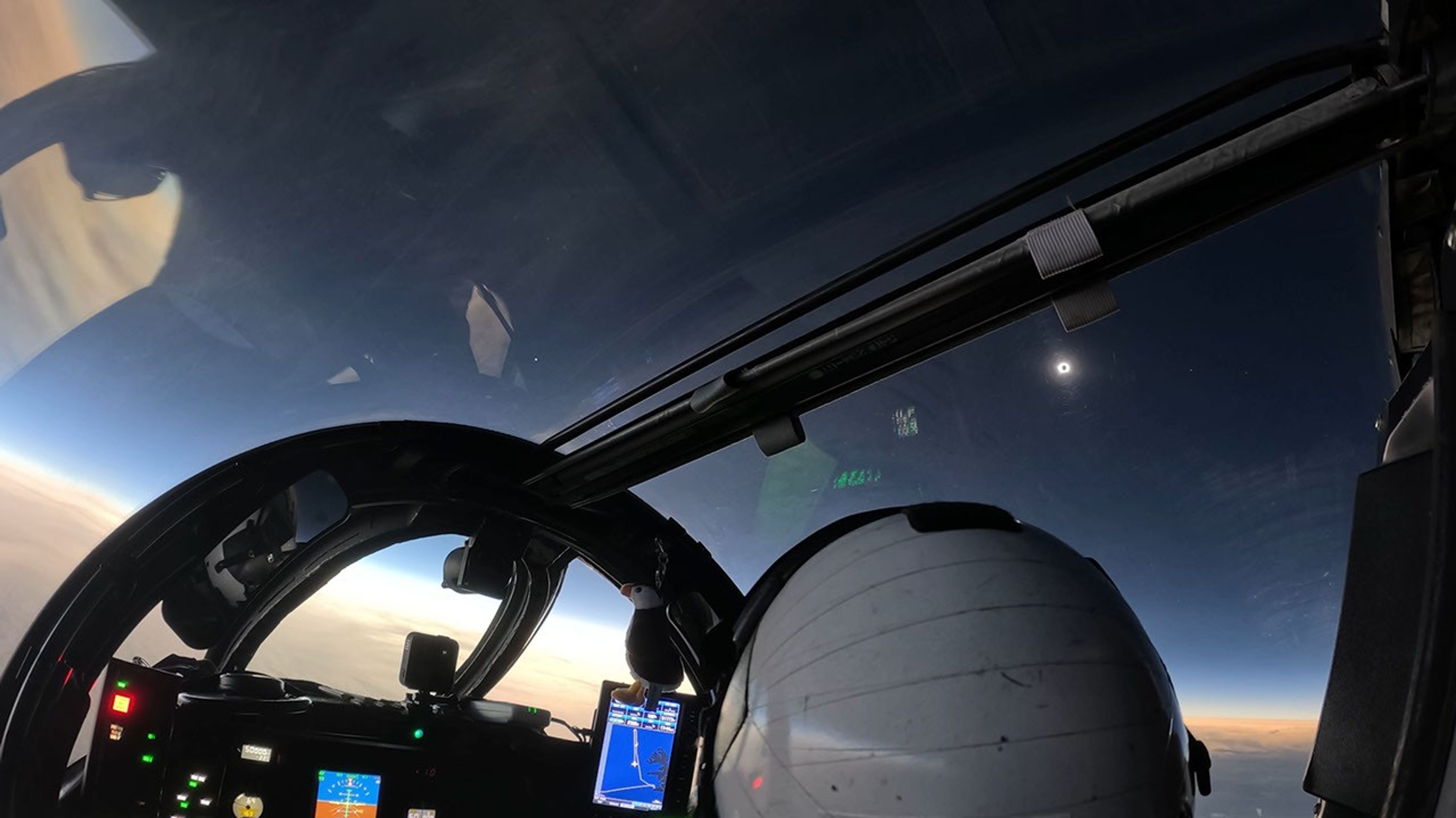 A solar eclipse as viewed by a pilot from an aircraft cockpit.