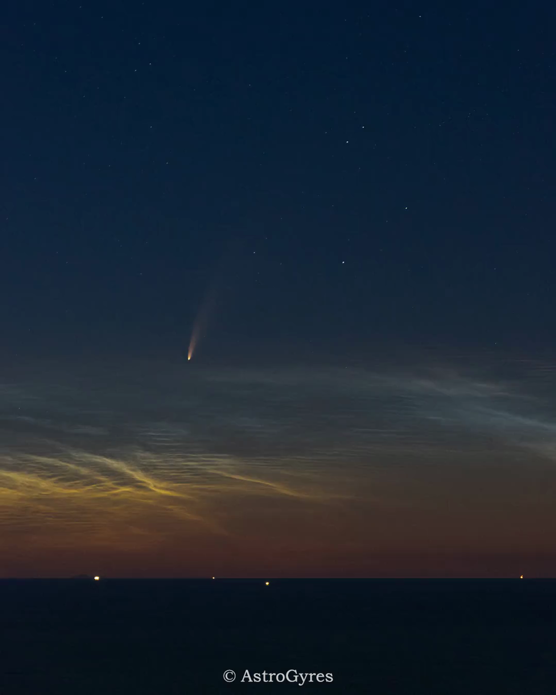 Comet in the sky low to the horizon above the clouds.