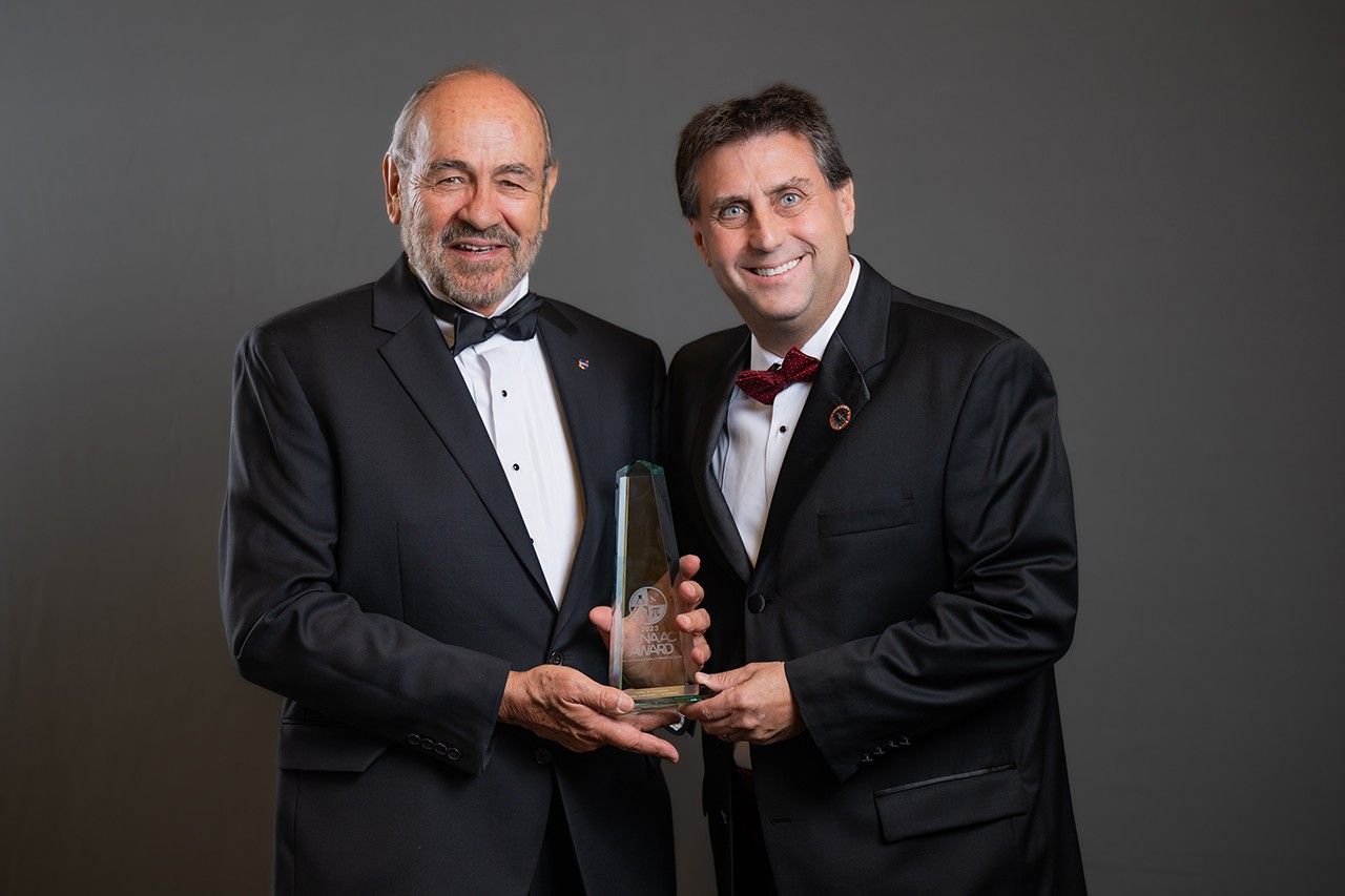 Carlos Fontanot (left) receives the Great Minds in STEM Lifetime Achievement Award from Joel Montelbano, NASA at the Hispanic Engineer National Achievement Award Conference.