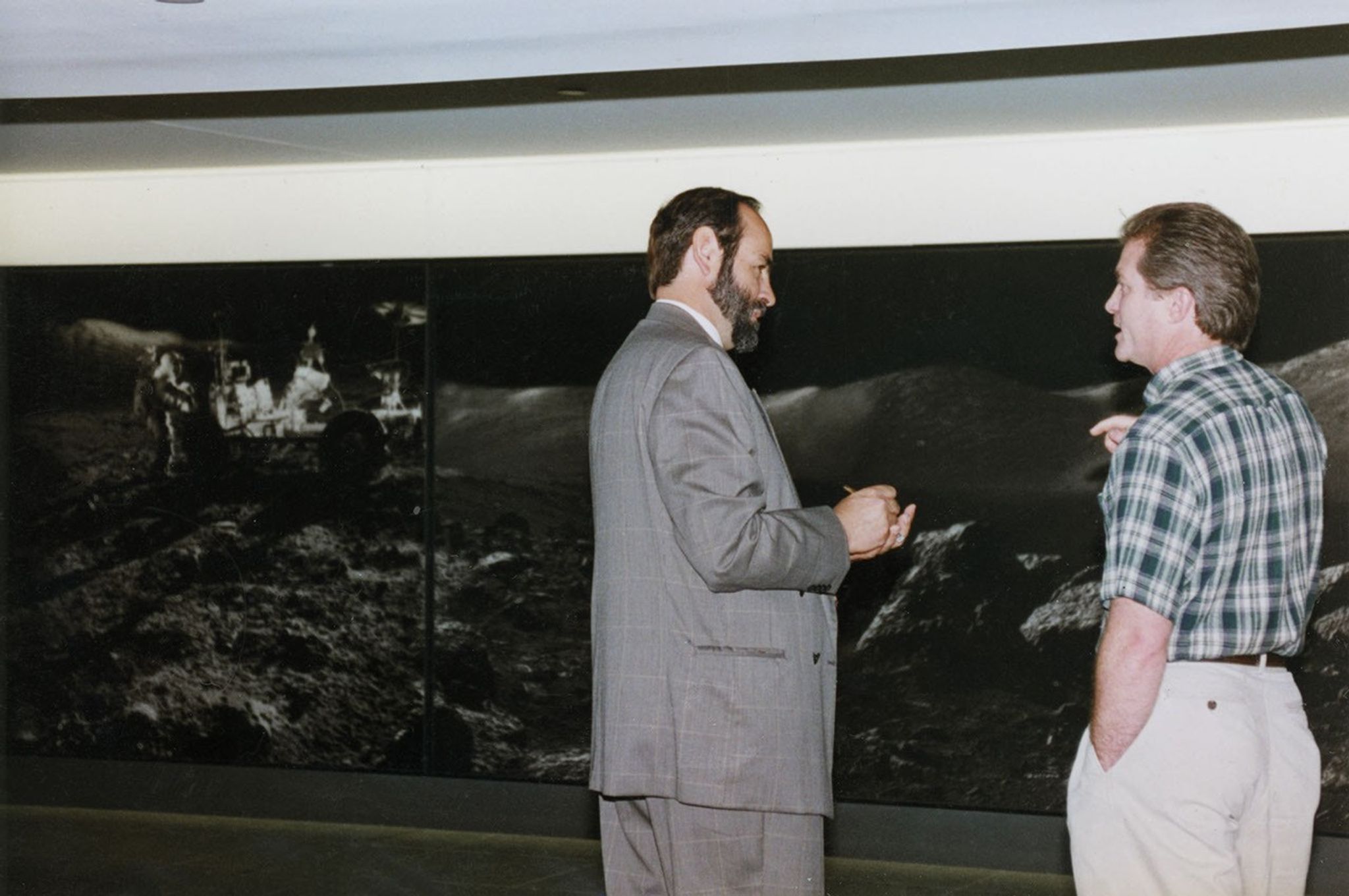 Carlos Fontanot (left) sets up a NASA imagery exhibit in the Houston Downtown Tunnel System.