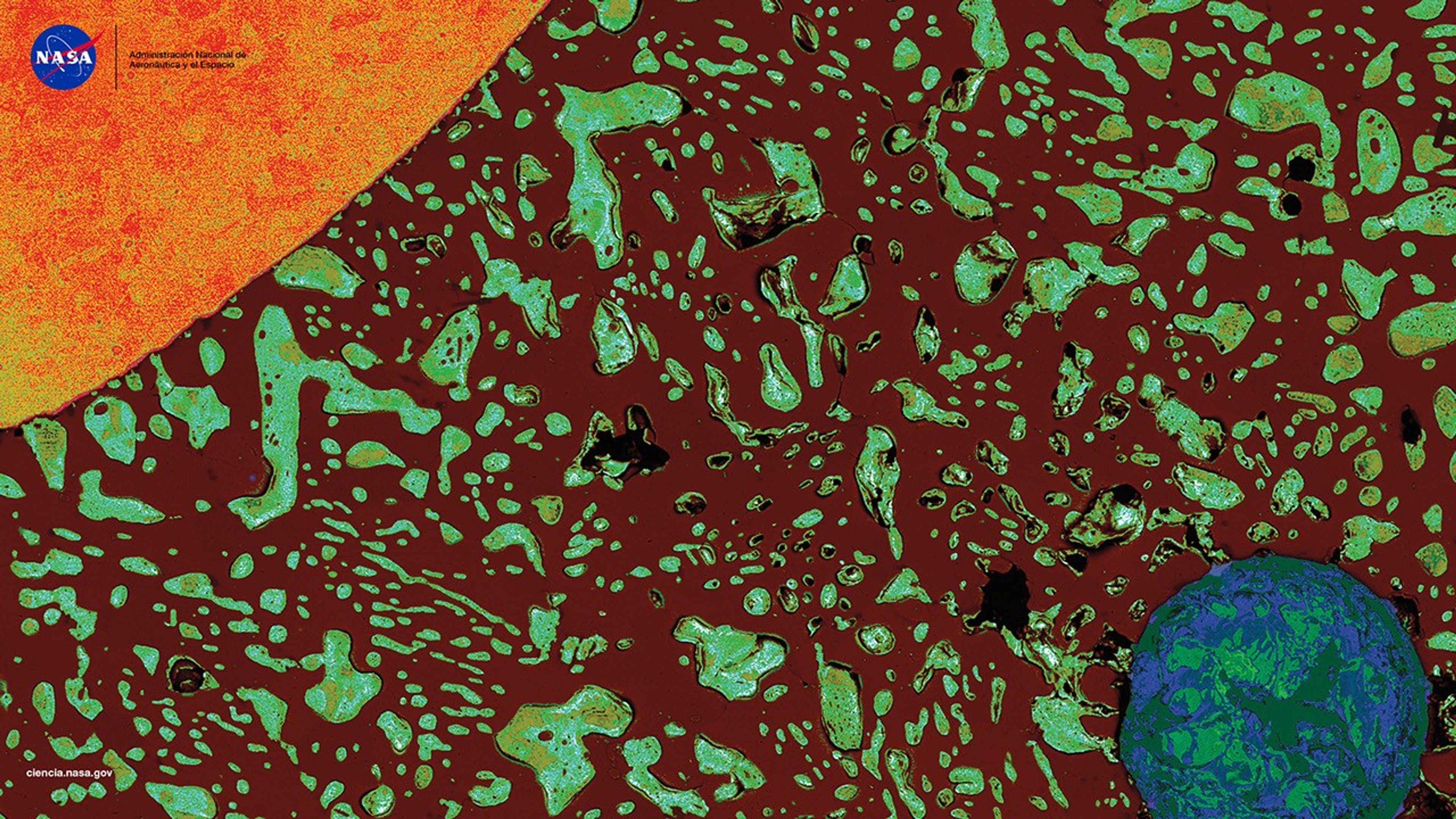 Sección transversal microscópica de una gota de soldadura que muestra un cable de cobre (naranja, arriba a la izquierda) y vacío (círculo azul verdoso, abajo a la derecha) rodeados por material de soldadura de color marrón oscuro y azul verdoso, que se asemeja a un sistema solar con el cable como el sol y el vacío como la Tierra.