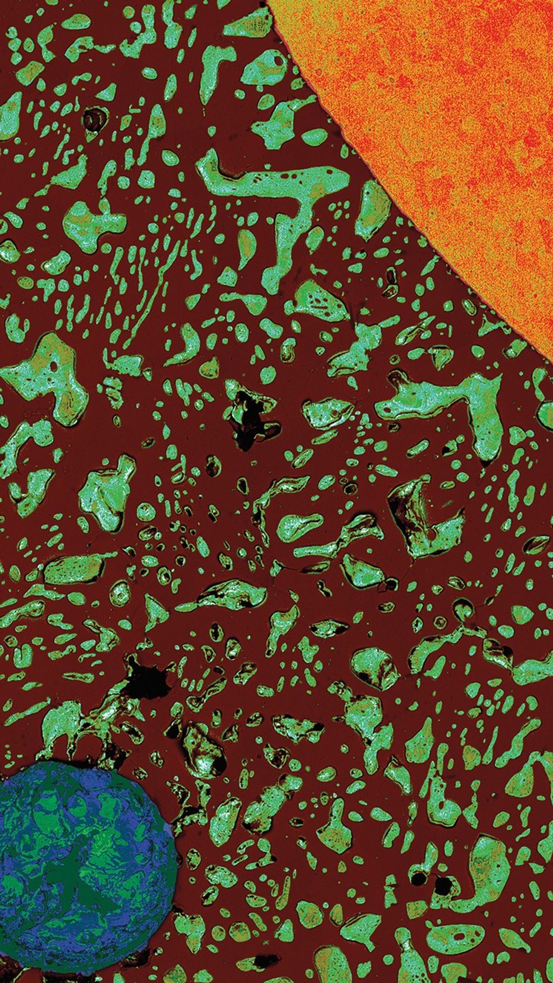 Microscopic cross-section of a solder bead showing a copper wire (orange, upper left) and void (blue-green circle, lower right) surrounded by dark brown and greenish-blue solder material, resembling a solar system with the wire as the sun and void as Earth.