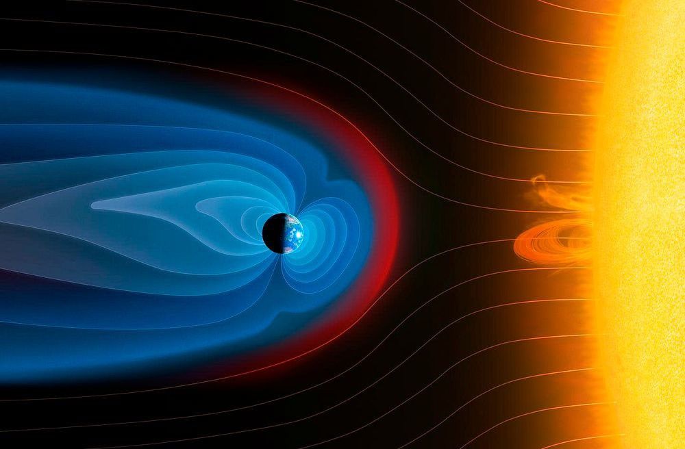 A conceptual illustration with a large, yellow, glowing Sun on the right side. Radiating from the Sun is the solar wind, visualized as delicate, sweeping, curved light lines. In the center is a small, dark Earth, surrounded by a large, protective bubble of glowing blue light that forms a tail extending far to the left. The front of this blue bubble is a distinct, fiery red and orange curved barrier, the shock where the solar wind collides with Earth's magnetic field.