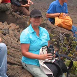 Photo of a woman sitting on a rock