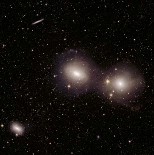 A deep-space image of the Dorado group of galaxies from ESA’s Euclid telescope showing spiral and elliptical galaxies with elongated tidal tails and distorted structures caused by gravitational interactions. The images illustrate examples used in the Galaxy Zoo “Tidal Tales” citizen science project where volunteers help identify galaxy mergers and tidal features.