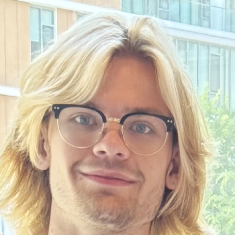 Photo of a smiling man with long shaggy blond hair and glasses