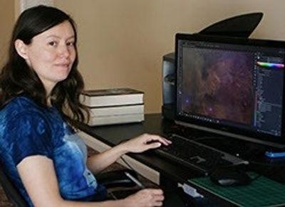 Photo of a woman sitting at a computer desk