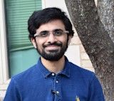 Portrait photo of a smiling bearded man