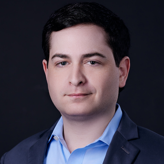 Portrait photo of a man wearing a blue shirt and blazer