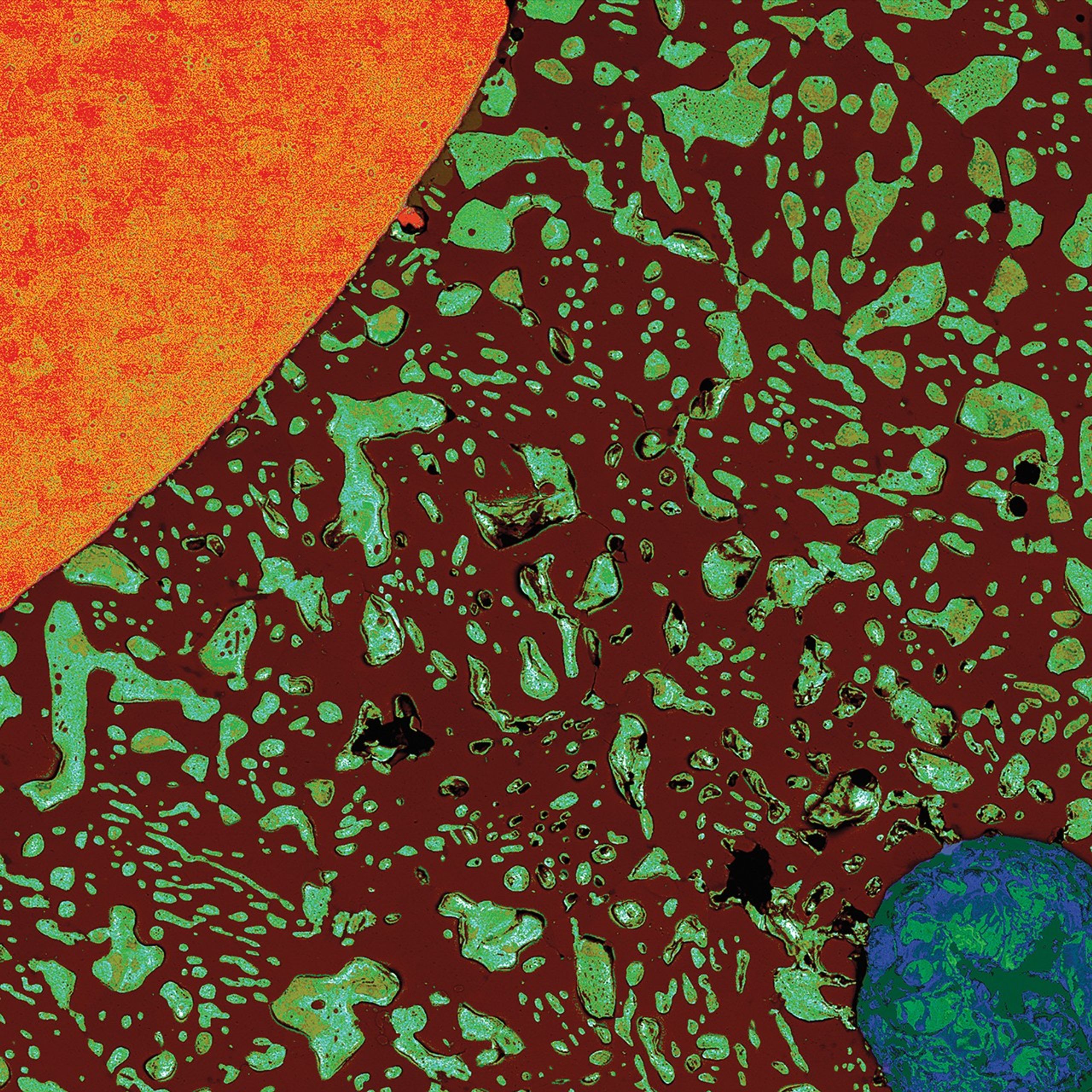 Microscopic cross-section of a solder bead showing a copper wire (orange, upper left) and void (blue-green circle, lower right) surrounded by dark brown and greenish-blue solder material, resembling a solar system with the wire as the sun and void as Earth.