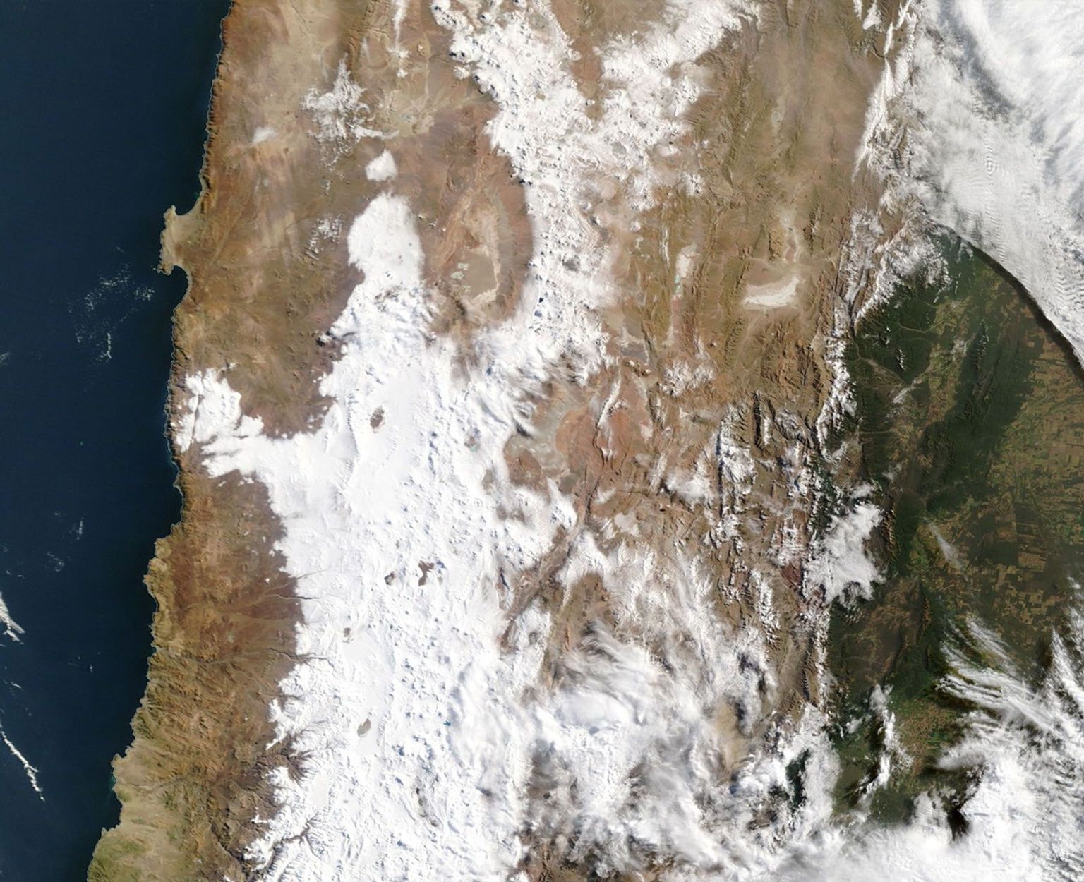 An image from orbit from the Terra satellite shows the results of a snowstorm in the Andes mountains in Chile and also to the west in the Atacama desert.