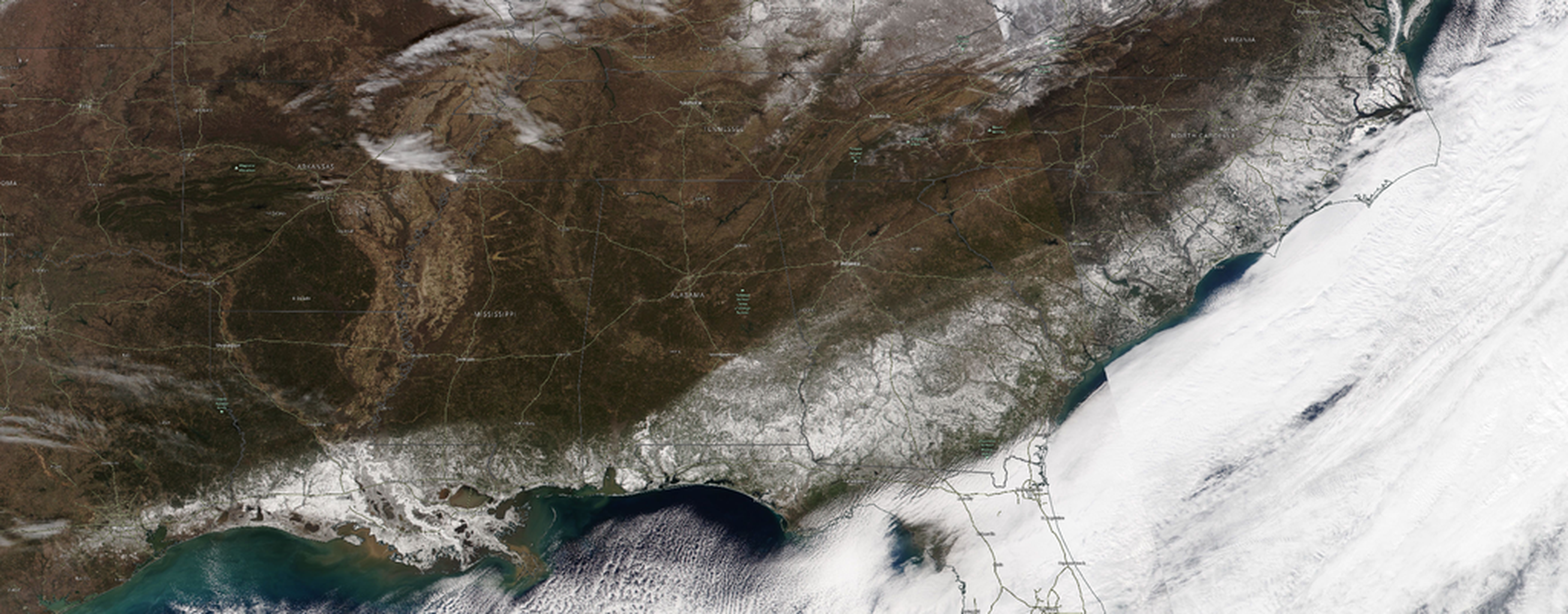 An image of the southeastern United States from orbit showing snow blanketing multiple states including Florida and Georgia.