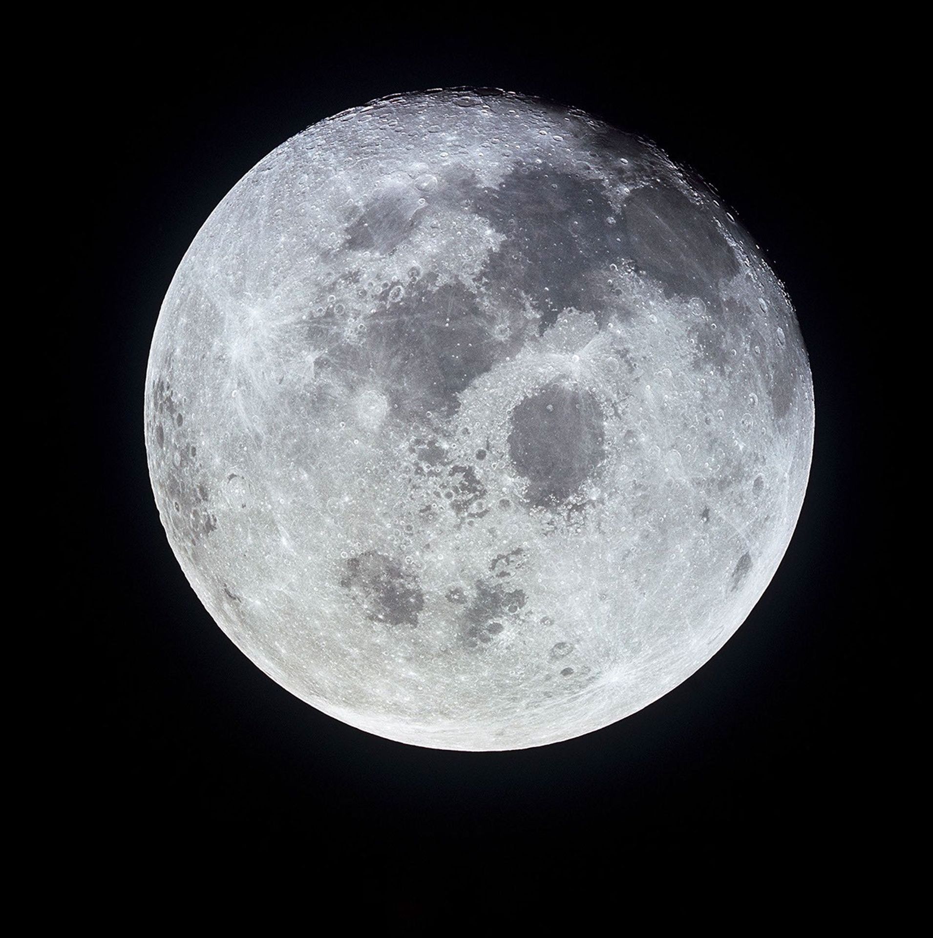 High-resolution image of the full Moon taken from space, showing detailed surface features including craters and dark lunar maria against a black background.