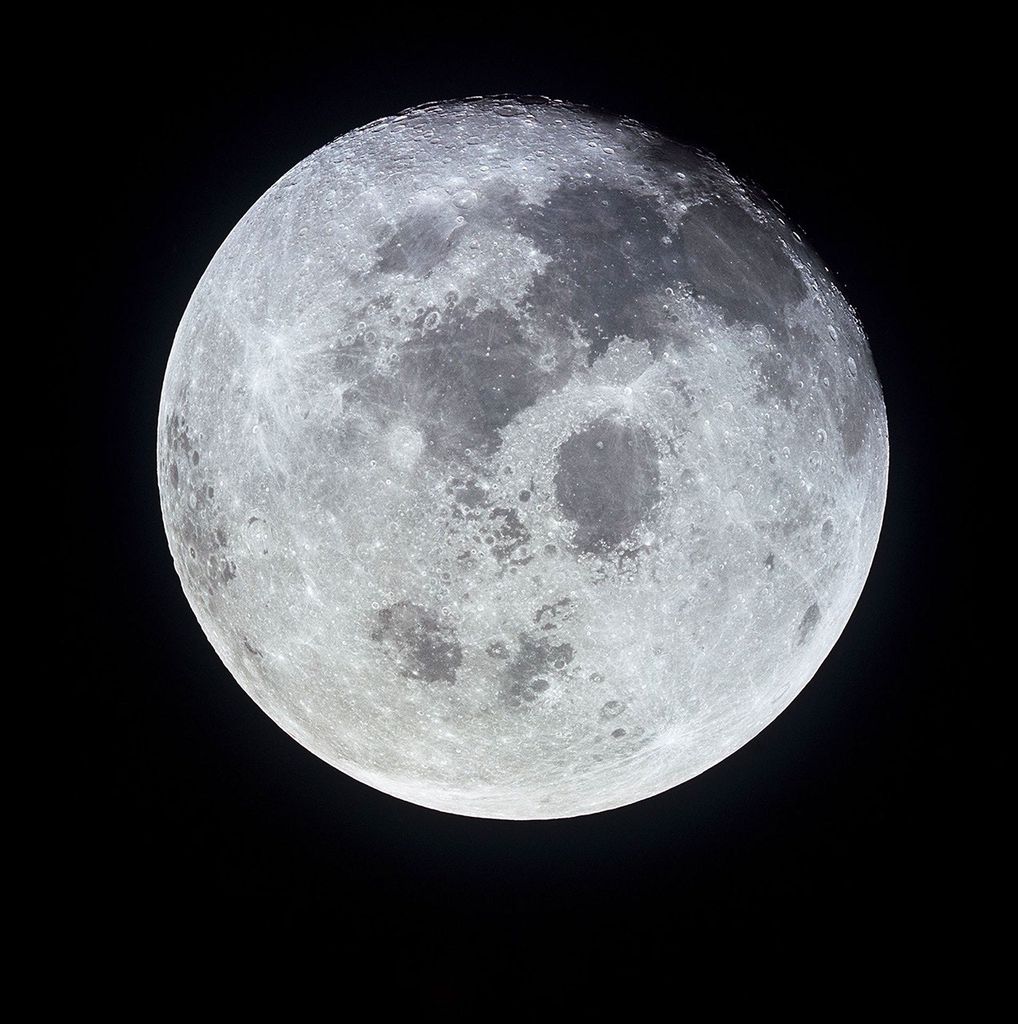 High-resolution image of the full Moon taken from space, showing detailed surface features including craters and dark lunar maria against a black background.